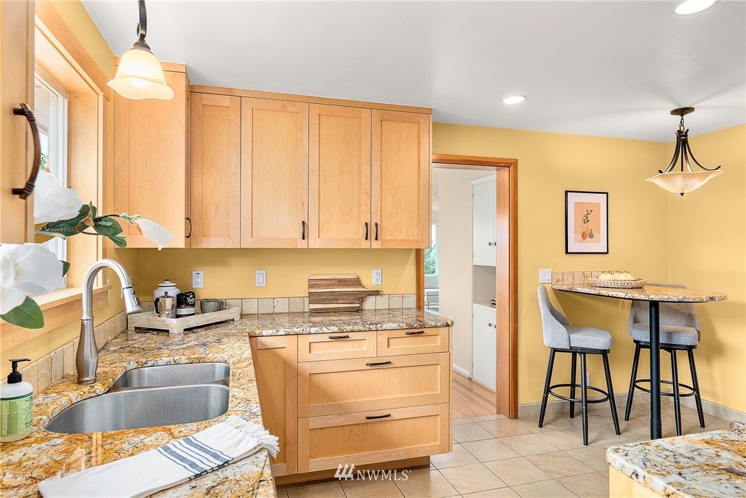 7139 South Sunnycrest Road Seattle, WA 98178 - Photo 9 of 28 a kitchen that has a sink and chairs