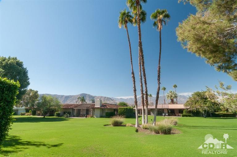 11 Wake Forest Court Rancho Mirage, CA 92270 - Photo 1 of 25 a view of a garden with a building in the background