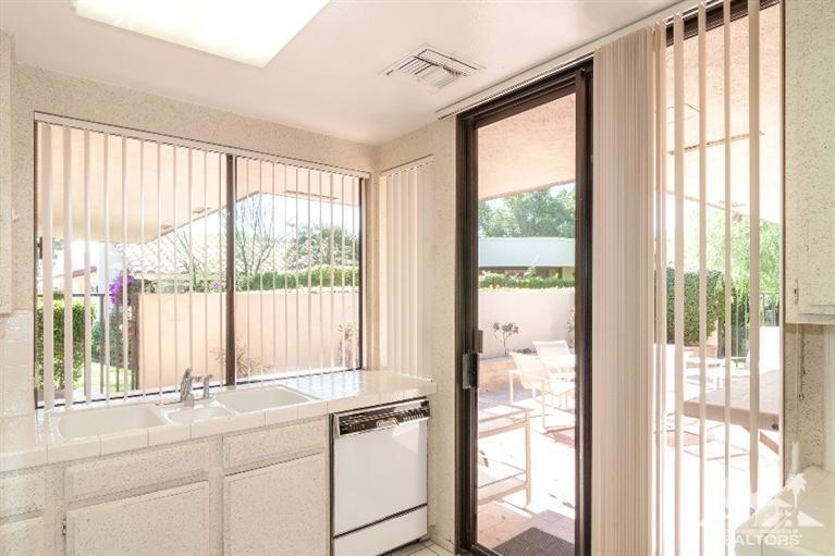 11 Wake Forest Court Rancho Mirage, CA 92270 - Photo 17 of 25 a kitchen with a large window and a bed