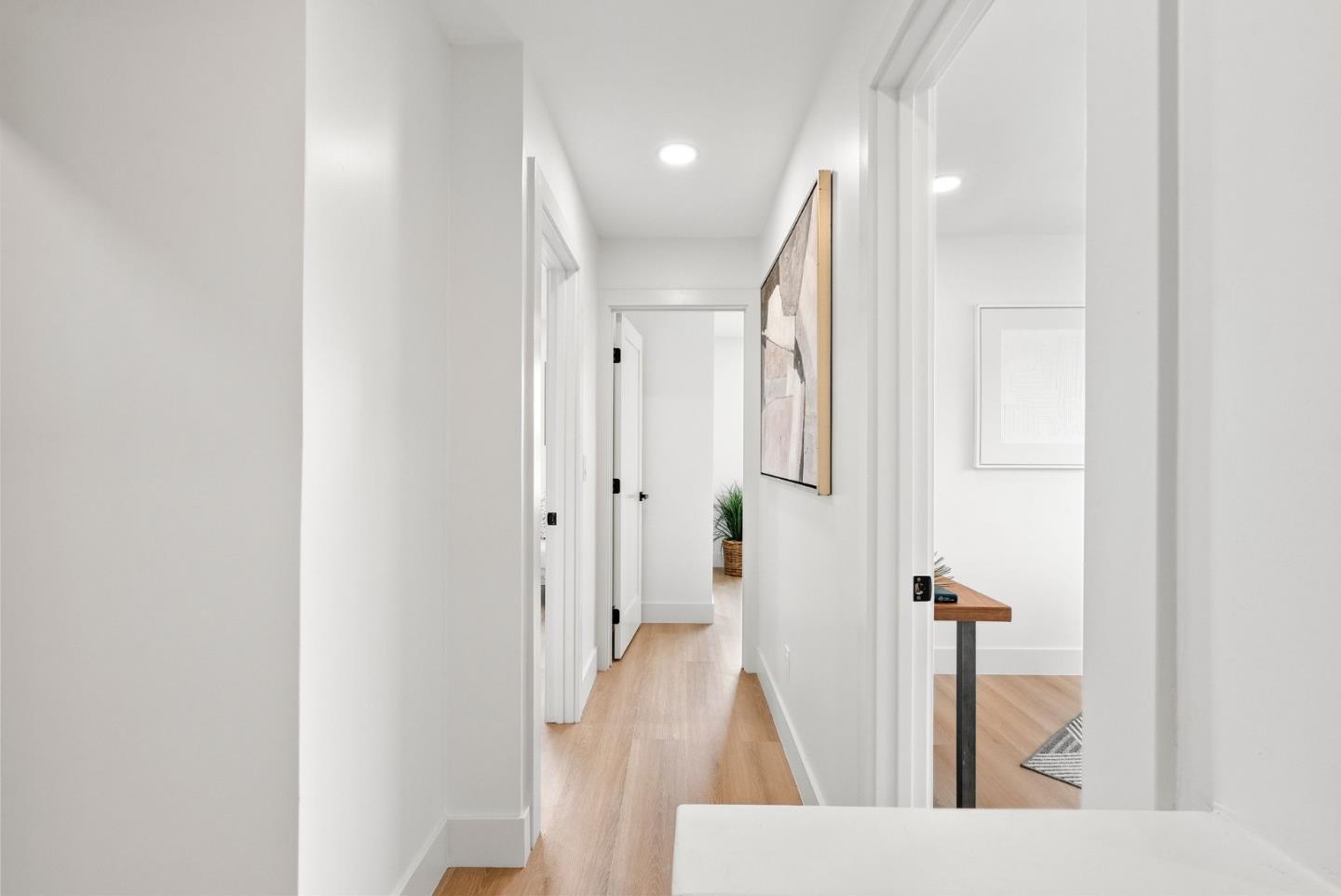 384 Lynbrook Drive Pacifica, CA 94044 - Photo 14 of 40 a view of a hallway with wooden floor and staircase