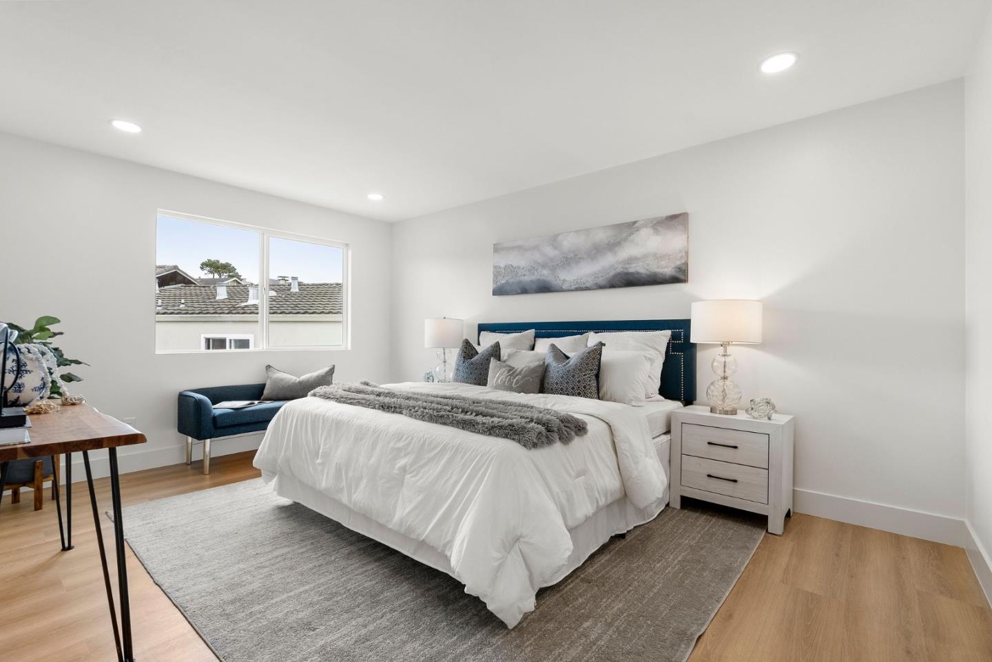 384 Lynbrook Drive Pacifica, CA 94044 - Photo 17 of 40 a bedroom with a bed and a table in it