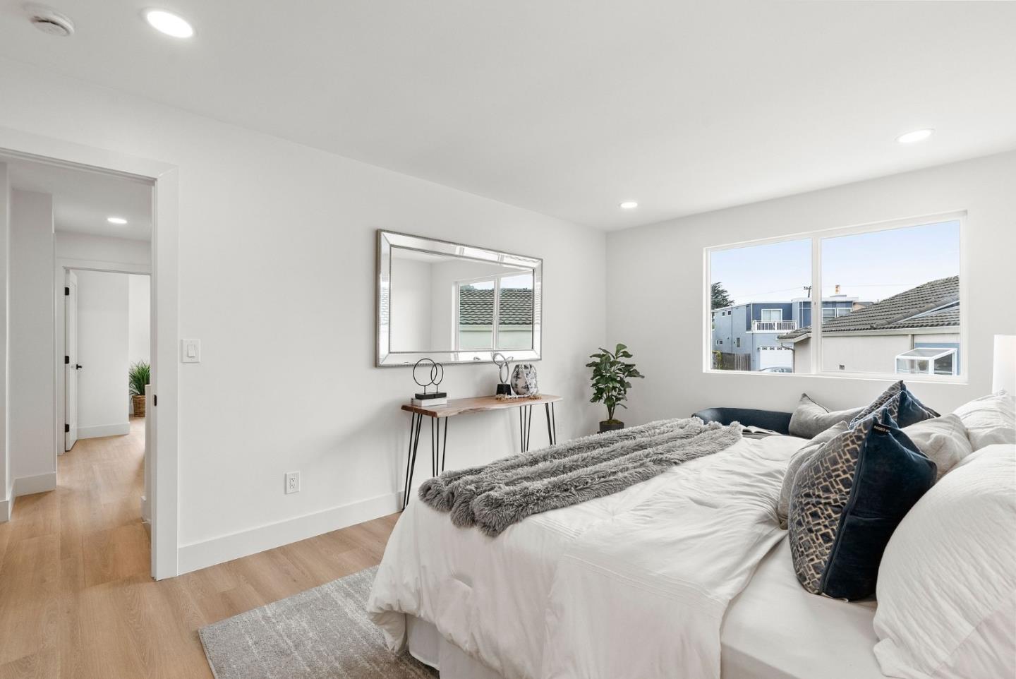 384 Lynbrook Drive Pacifica, CA 94044 - Photo 18 of 40 a bedroom with a large bed and a wooden floor