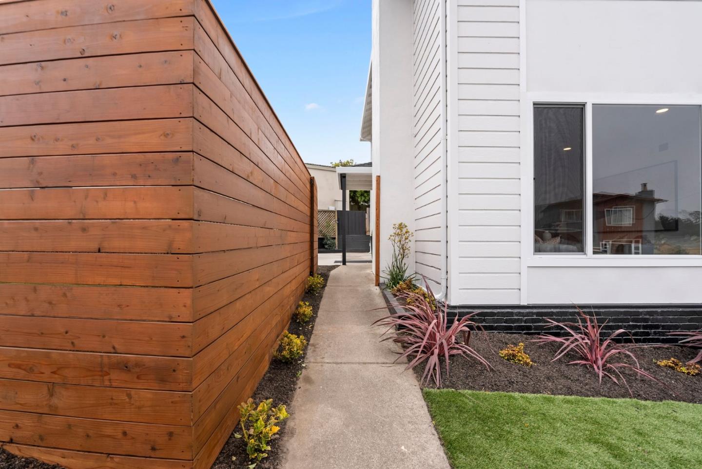 384 Lynbrook Drive Pacifica, CA 94044 - Photo 3 of 40 a view of a pathway with a chair and front door