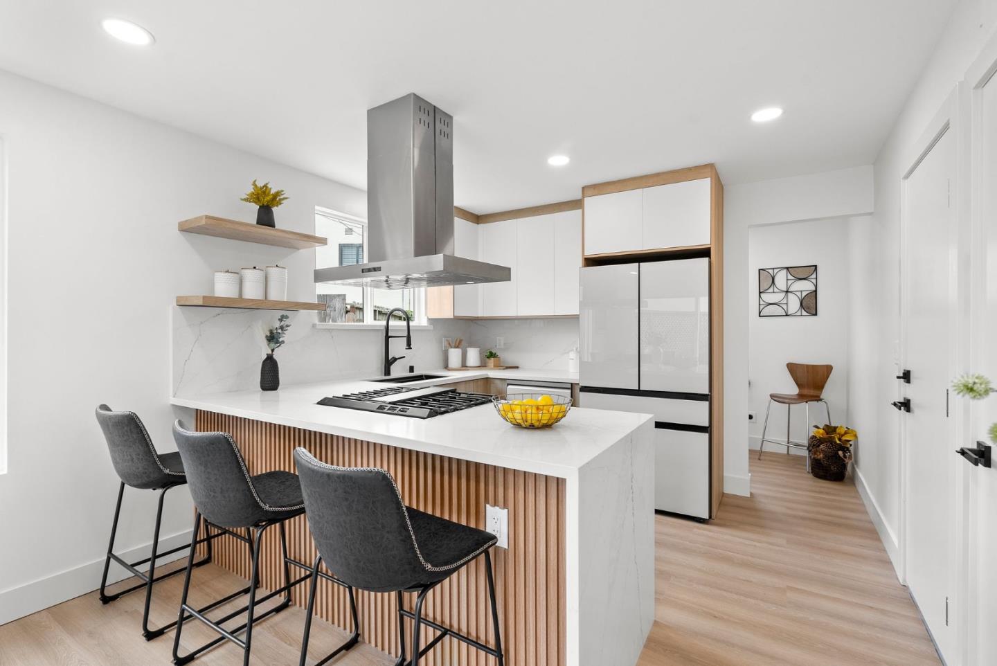 384 Lynbrook Drive Pacifica, CA 94044 - Photo 10 of 40 a kitchen with a sink a stove a refrigerator and a dining table with wooden floor