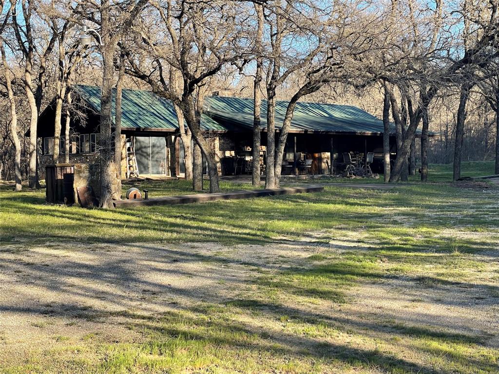3141 Rogers Road Jacksboro, TX 76458 - Photo 16 of 40 a view of a house in a big yard with large trees