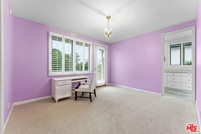 a spacious bedroom with a bed and a window