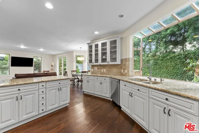 a kitchen with sink and large window