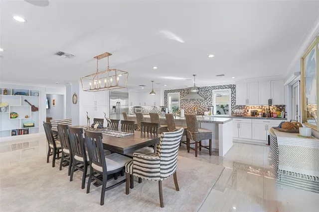 a view of a dining room with furniture and chandelier