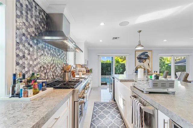 a kitchen with lots of counter top space and wooden floor