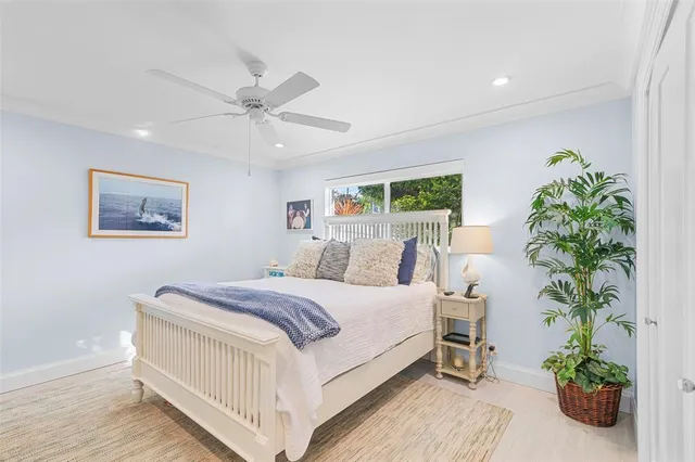 a bed room with a bed and a potted plant