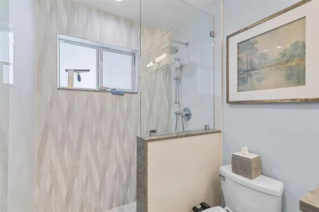 a bathroom with a shower toilet and sink