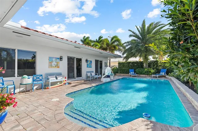 a view of a house with backyard porch and sitting area