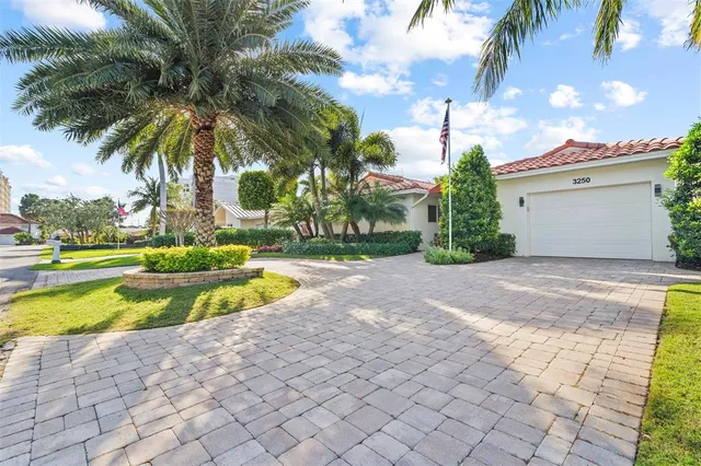 a view of a swimming pool with a yard and palm trees