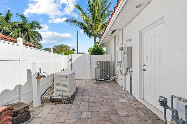 a view of a patio with a table and chairs and potted plants
