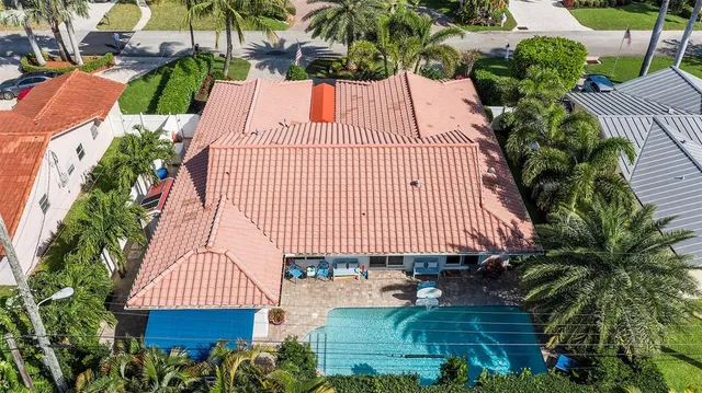 an aerial view of a house with a yard and potted plants