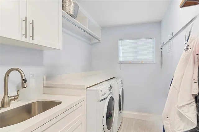a view of a kitchen with sink washer and dryer