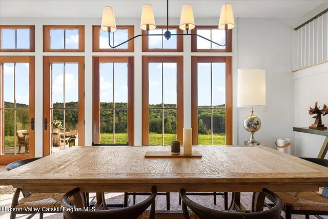 a kitchen with stainless steel appliances a stove a sink and white cabinets