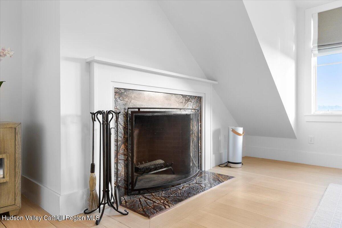 150 Harrington Drive Austerlitz, NY 12017 - Photo 29 of 82 a living room with a fireplace and a rug