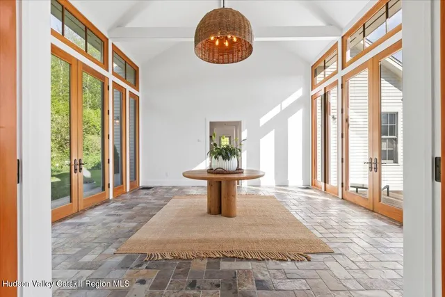a living room with furniture and large windows