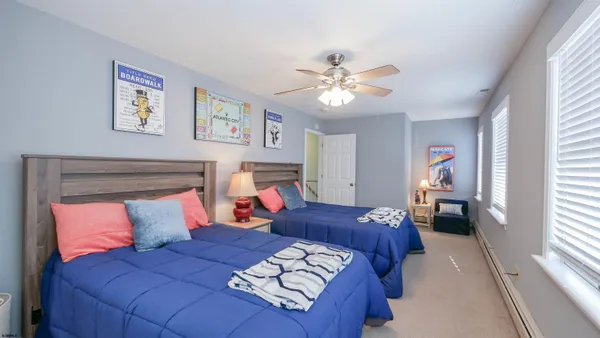 a bedroom with a large bed and a chandelier