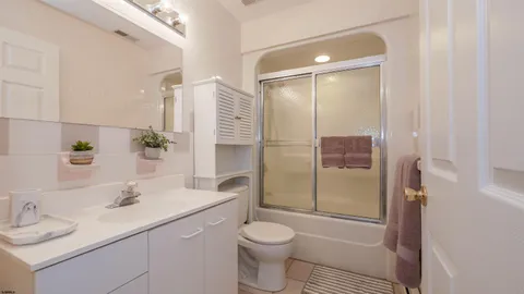 a bathroom with a sink toilet vanity and shower