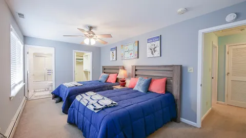 a bedroom with a large bed and a chandelier