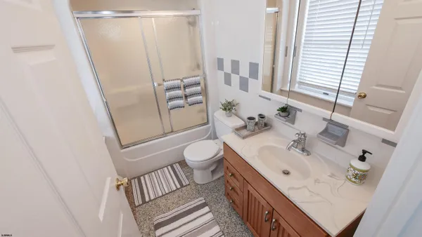 a bathroom with a sink a toilet and shower curtain
