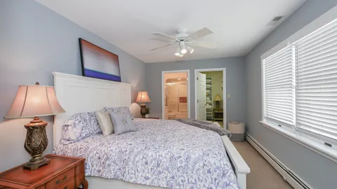 a bedroom with a large bed and a large window