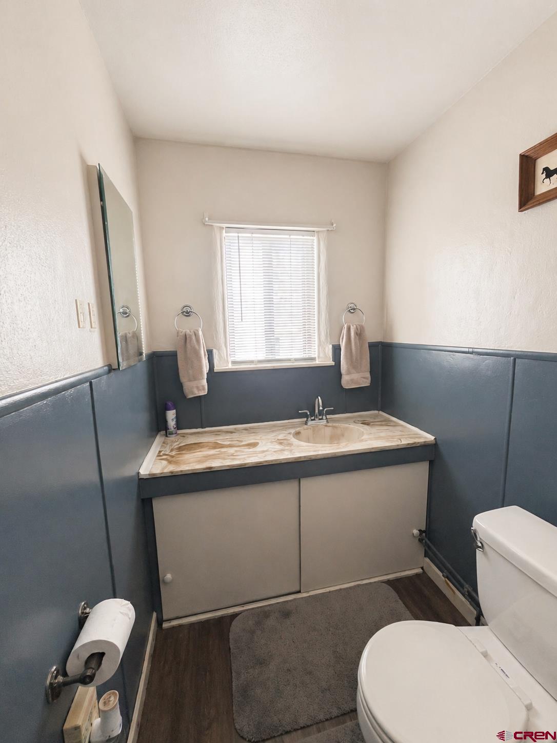 204 South Chestnut Street Cortez, CO 81321 - Photo 11 of 32 a bathroom with a granite countertop toilet sink and mirror