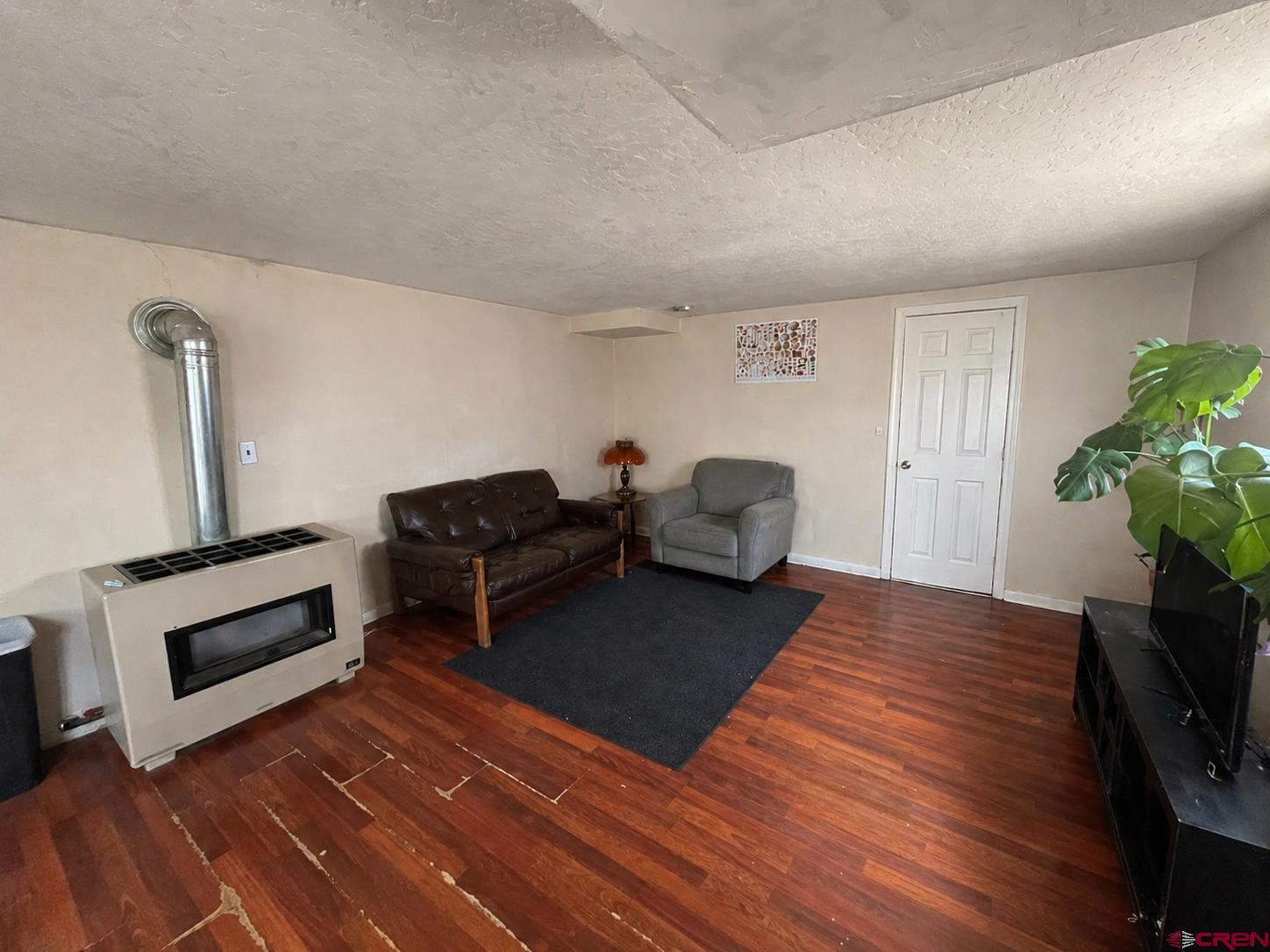 204 South Chestnut Street Cortez, CO 81321 - Photo 19 of 32 a living room with furniture and a fireplace