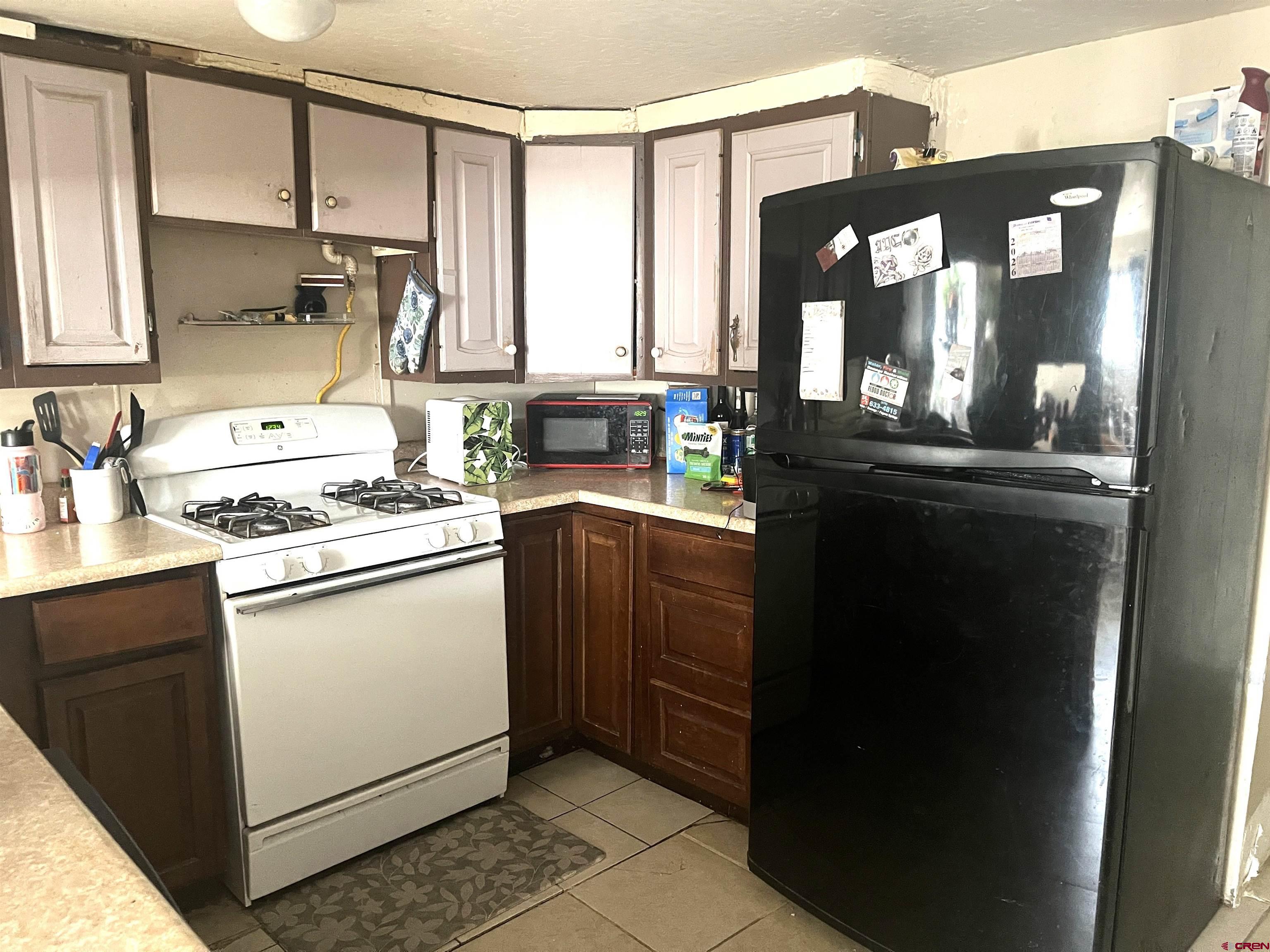 204 South Chestnut Street Cortez, CO 81321 - Photo 20 of 32 a kitchen with a sink stove and cabinets