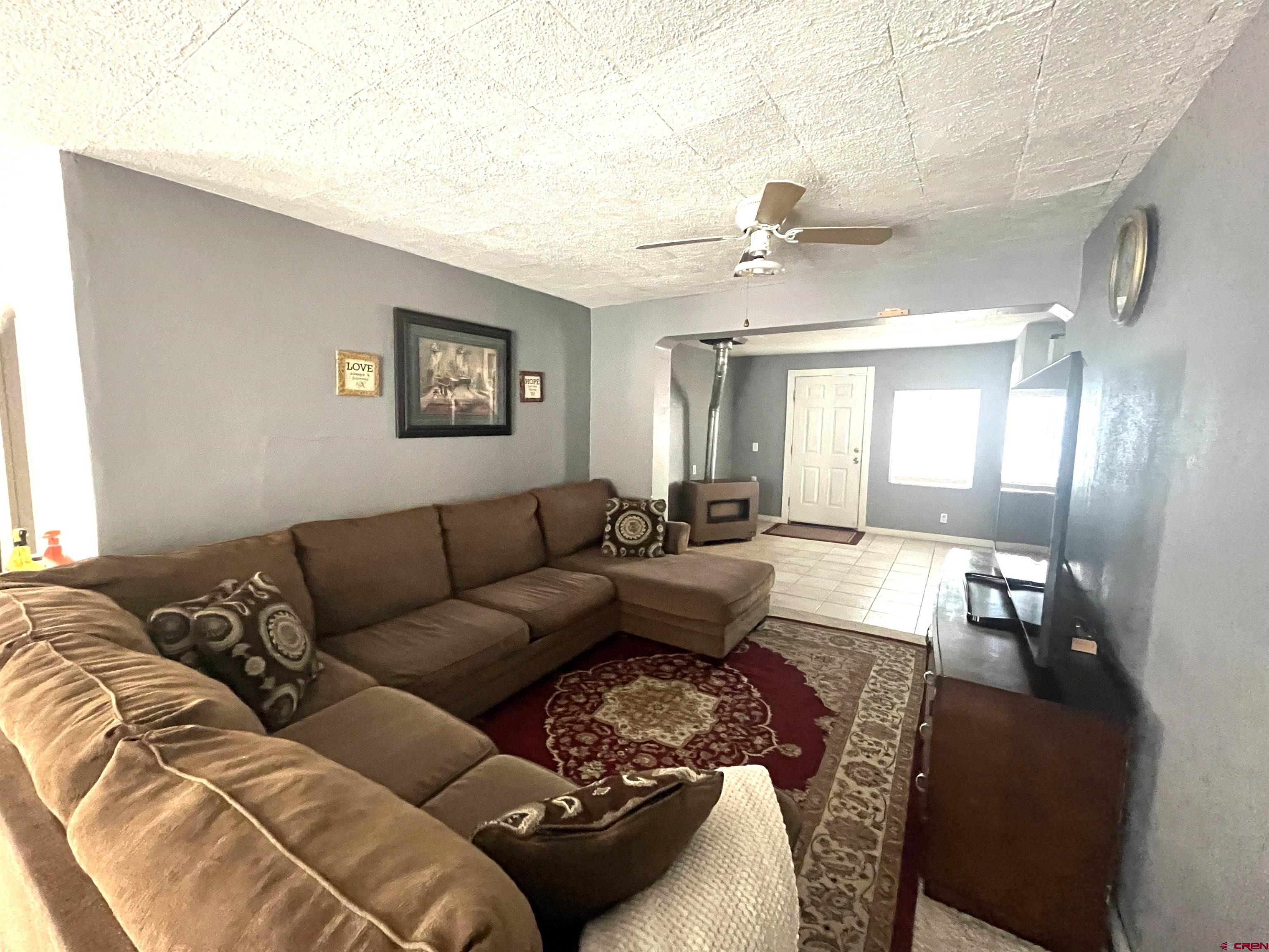 204 South Chestnut Street Cortez, CO 81321 - Photo 2 of 32 a living room with furniture and a chandelier