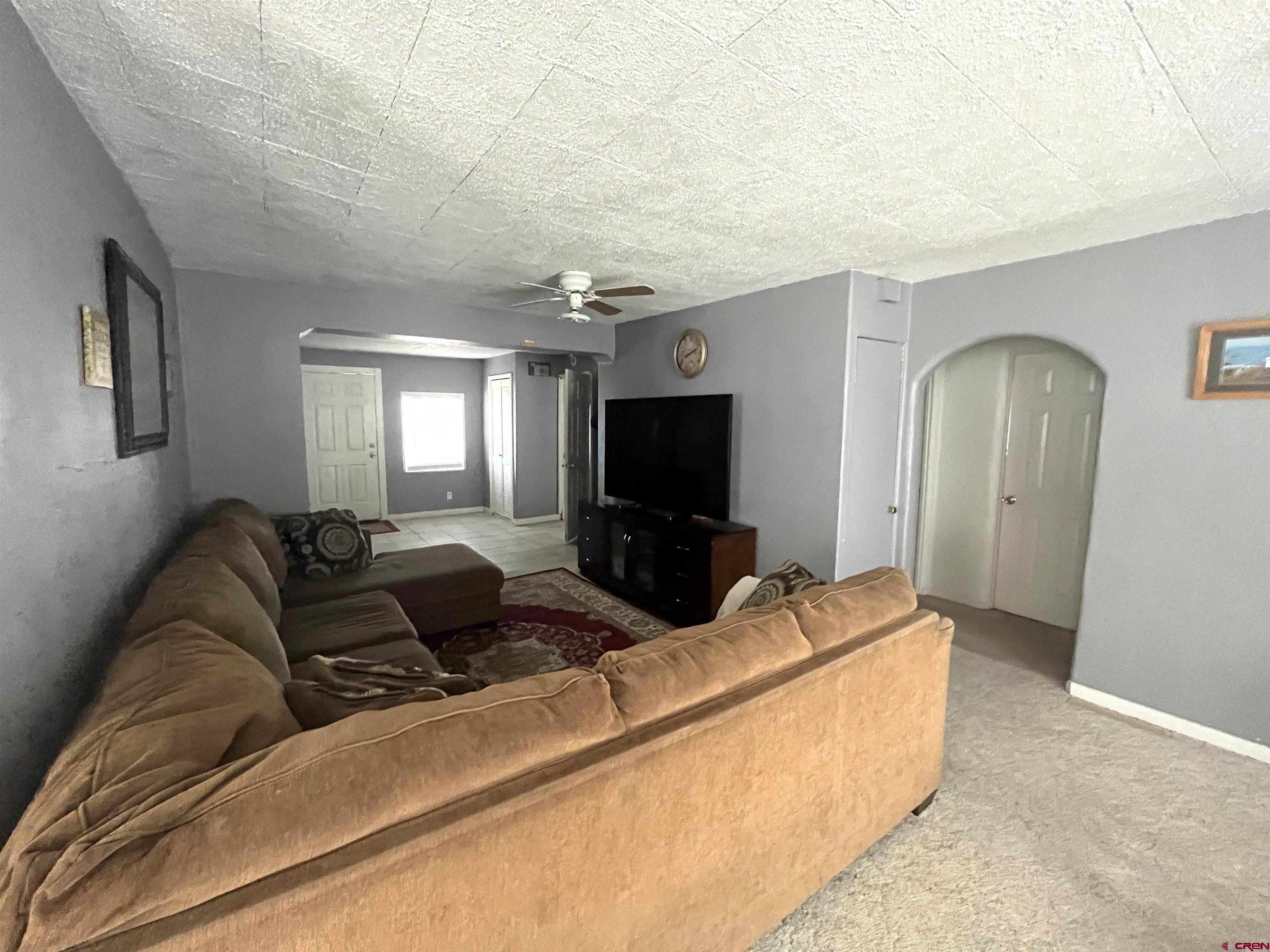 204 South Chestnut Street Cortez, CO 81321 - Photo 3 of 32 a living room with furniture and a flat screen tv