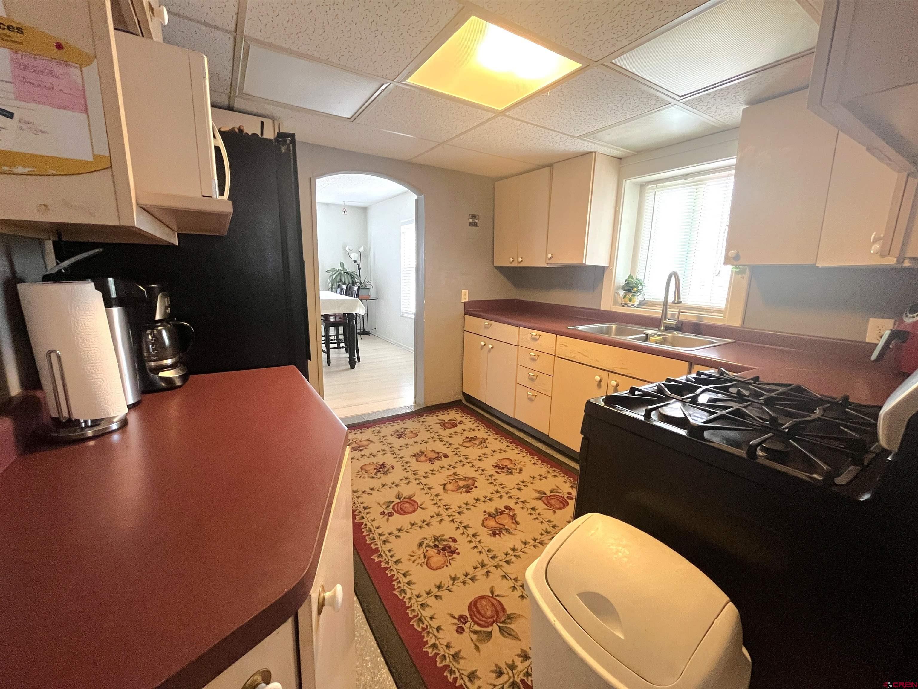 204 South Chestnut Street Cortez, CO 81321 - Photo 5 of 32 a kitchen with a sink stove and refrigerator