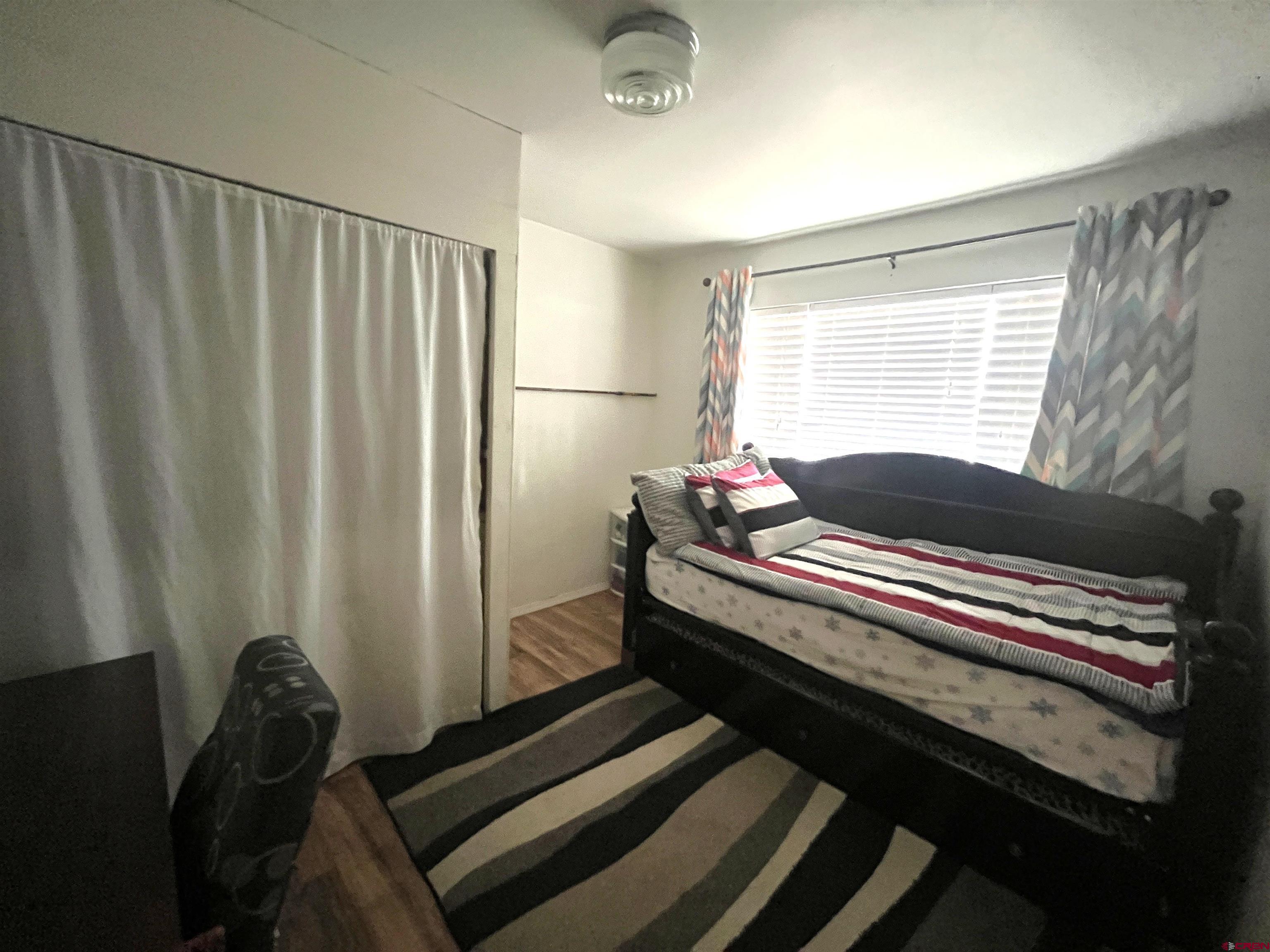 204 South Chestnut Street Cortez, CO 81321 - Photo 10 of 32 a bedroom with a bed and a window