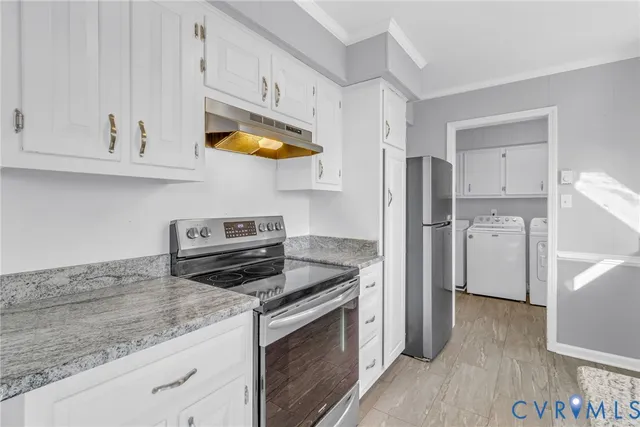 a kitchen with granite countertop a sink window and cabinets