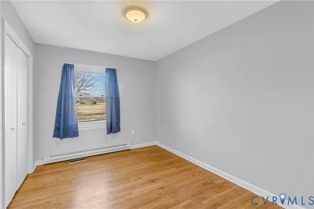 a view of an empty room and wooden floor
