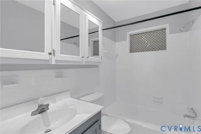 an empty room with a wooden floor and a window