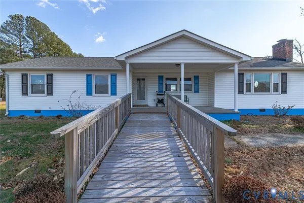 a pathway of a house with a yard