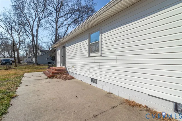 a backyard of a house with barbeque oven table and chairs