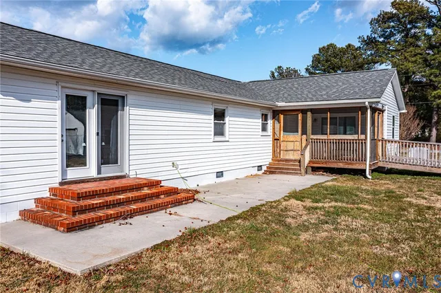 a view of house with backyard and deck