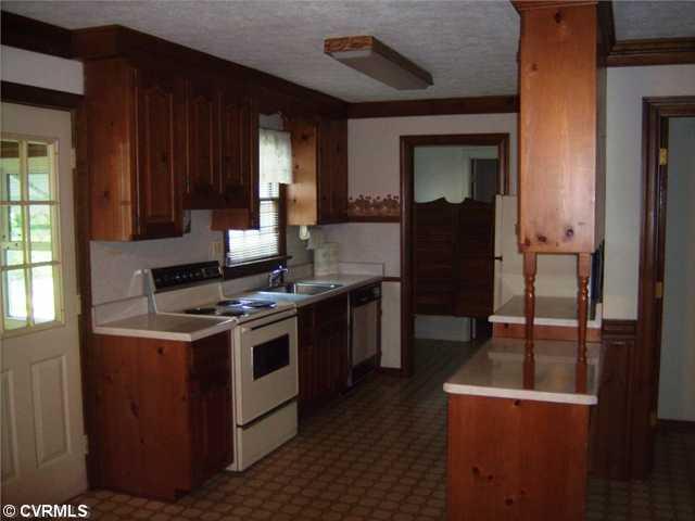 4400 Fordham Road Richmond, VA 23236 - Photo 3 of 12 Kitchen - Kitchen Offers Custom Made Raised Panel Pine Cabinets, Range, Disposal, Dishwasher, Refrigerator And Desk Area.
