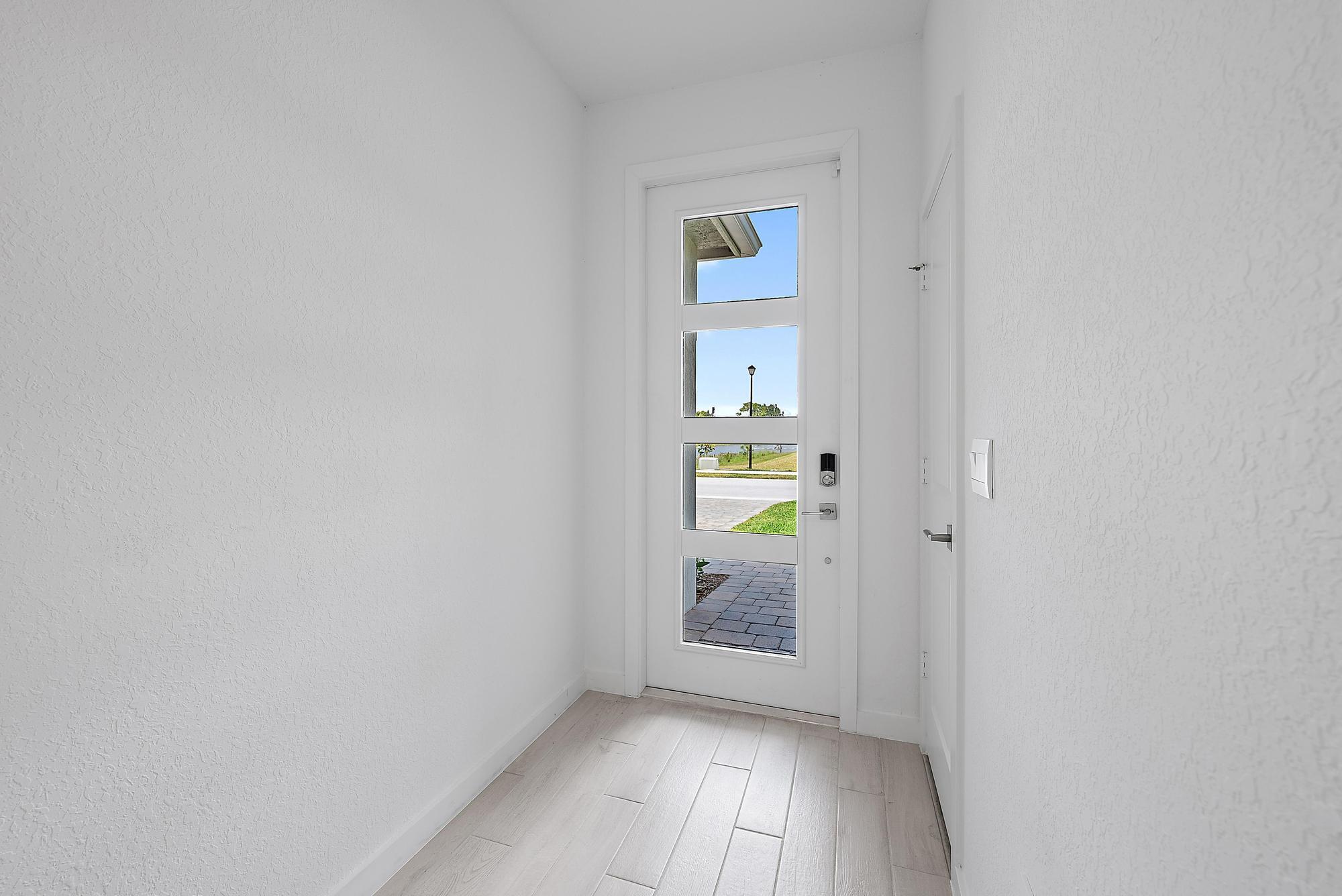 5880 Southeast Sky Blue Circle Stuart, FL 34997 - Photo 2 of 48 a view of an empty room and window