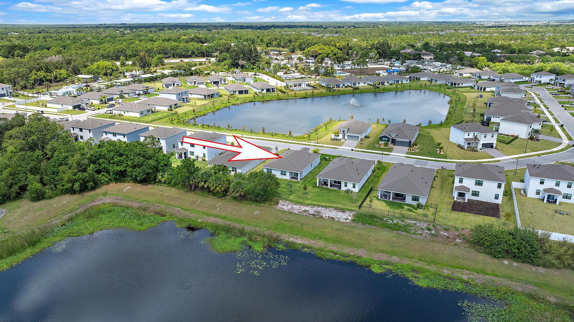 5880 Southeast Sky Blue Circle Stuart, FL 34997 - Photo 39 of 48 an aerial view of residential houses with outdoor space and lake view