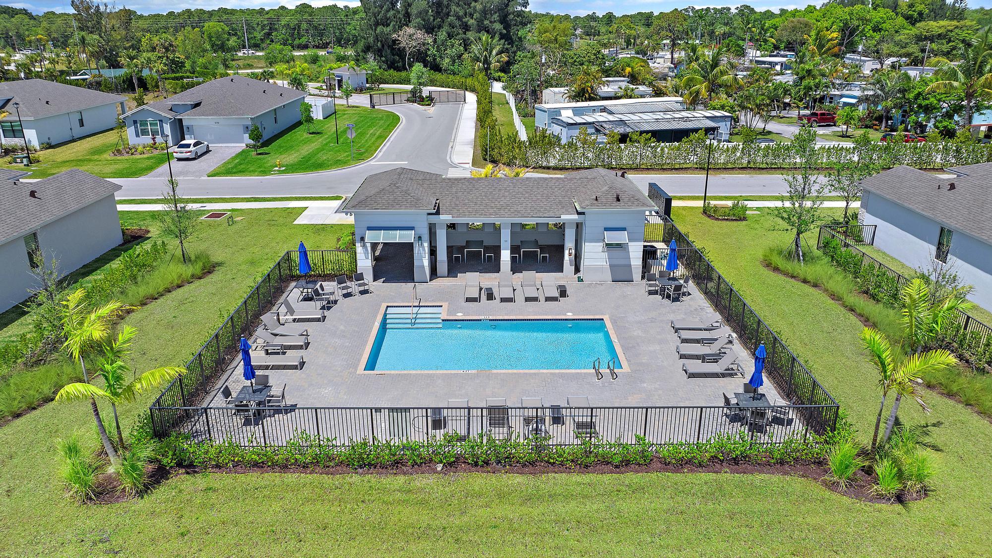 5880 Southeast Sky Blue Circle Stuart, FL 34997 - Photo 41 of 48 an aerial view of a house with a garden and lake view