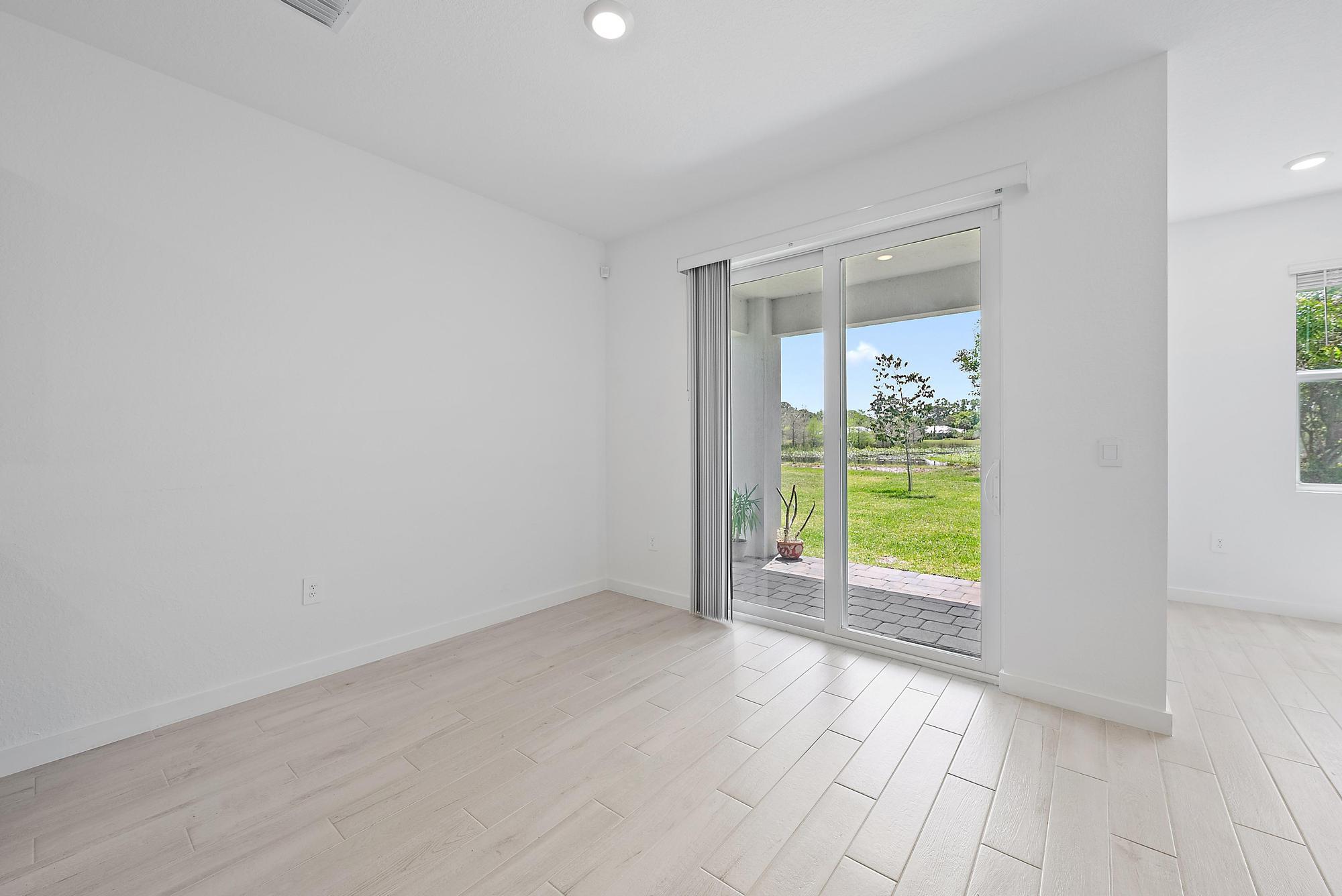 5880 Southeast Sky Blue Circle Stuart, FL 34997 - Photo 8 of 48 a view of an empty room with a window and kitchen view