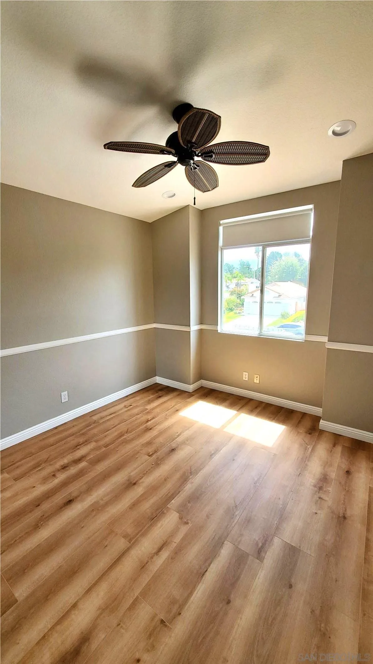 32812 Tulley Ranch Road Temecula, CA 92592 - Photo 11 of 27 an empty room with wooden floor and windows