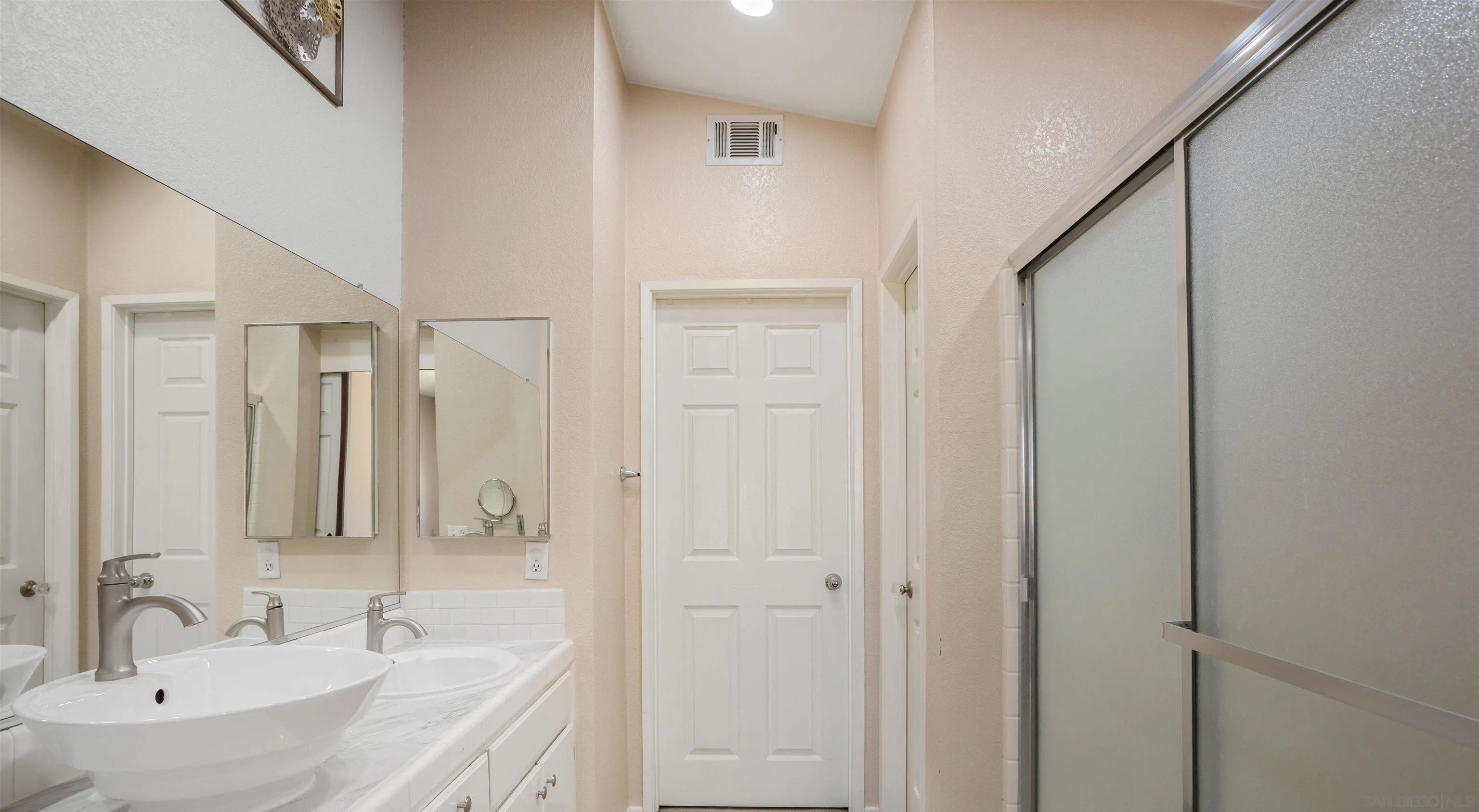 32812 Tulley Ranch Road Temecula, CA 92592 - Photo 14 of 27 a bathroom with a granite countertop sink a mirror and a shower