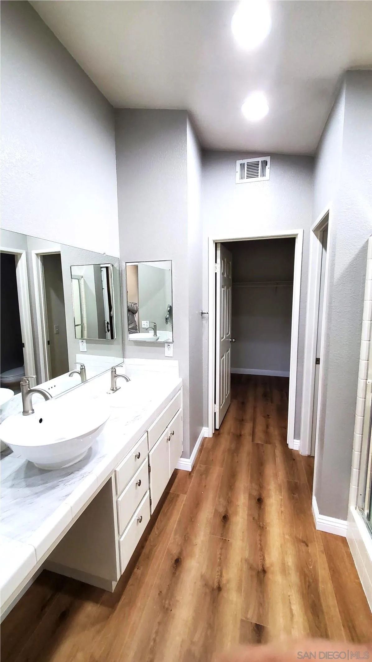 32812 Tulley Ranch Road Temecula, CA 92592 - Photo 15 of 27 a bathroom with a double vanity sink and a mirror