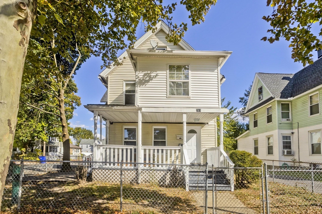 293 Eastern Avenue Springfield, MA 01109 - Photo 1 of 31 a view of a white house with iron fence